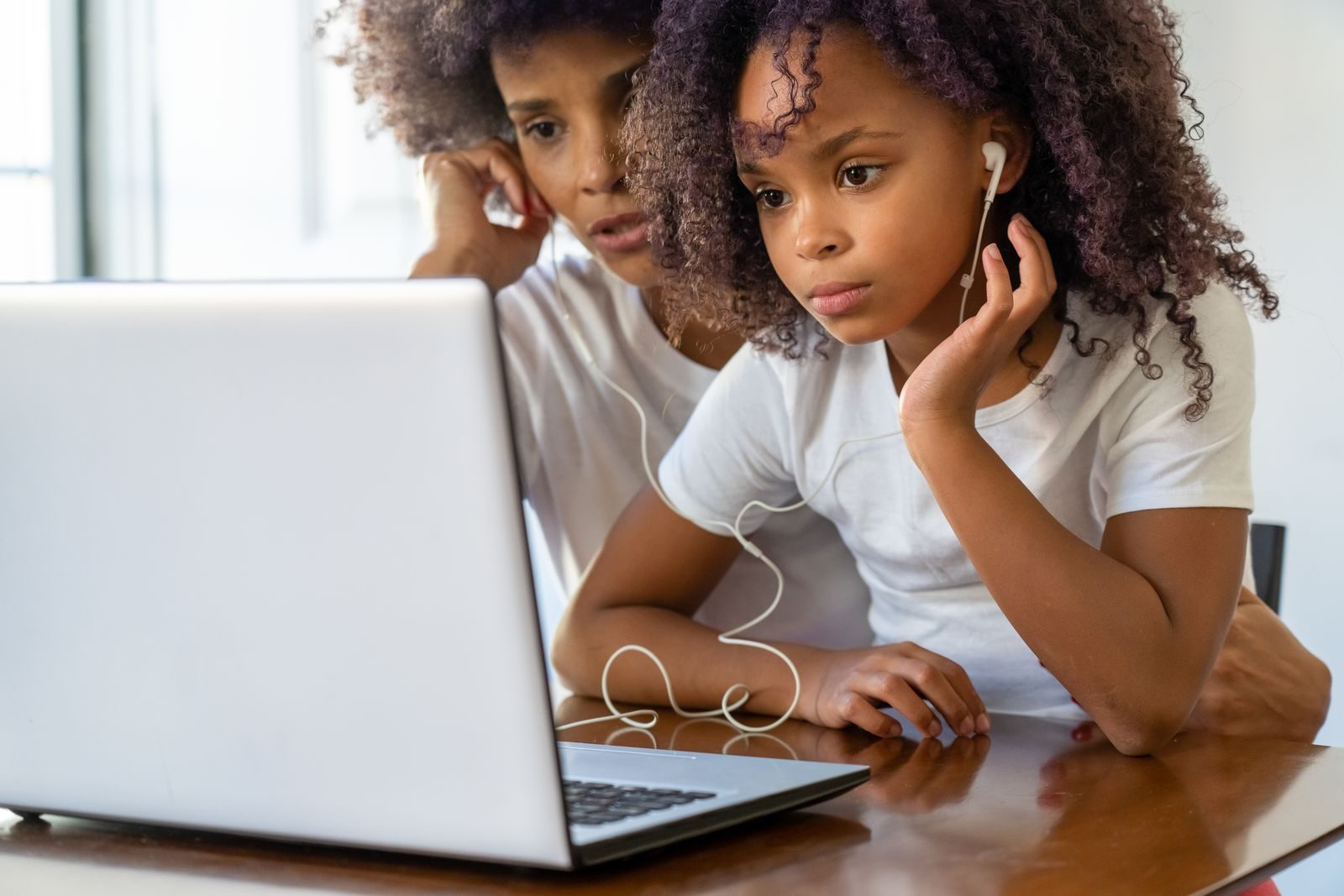 A parent and learner following a lesson together at home